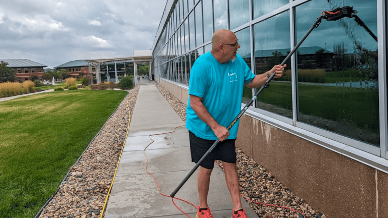 Founder Kevin Smith of Grace Window Cleaning working on a commercial window project